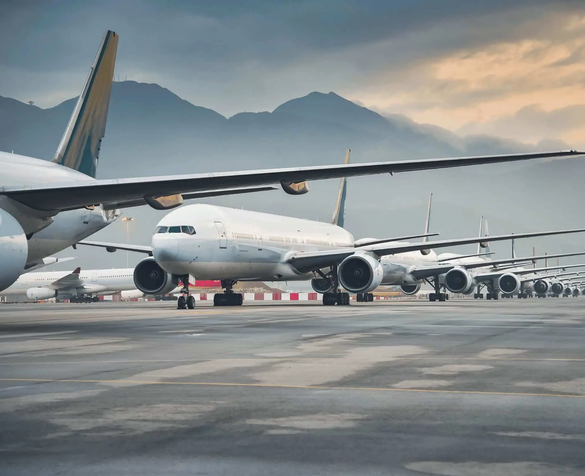 Commercial airplanes lined up on runway for long‑haul flights